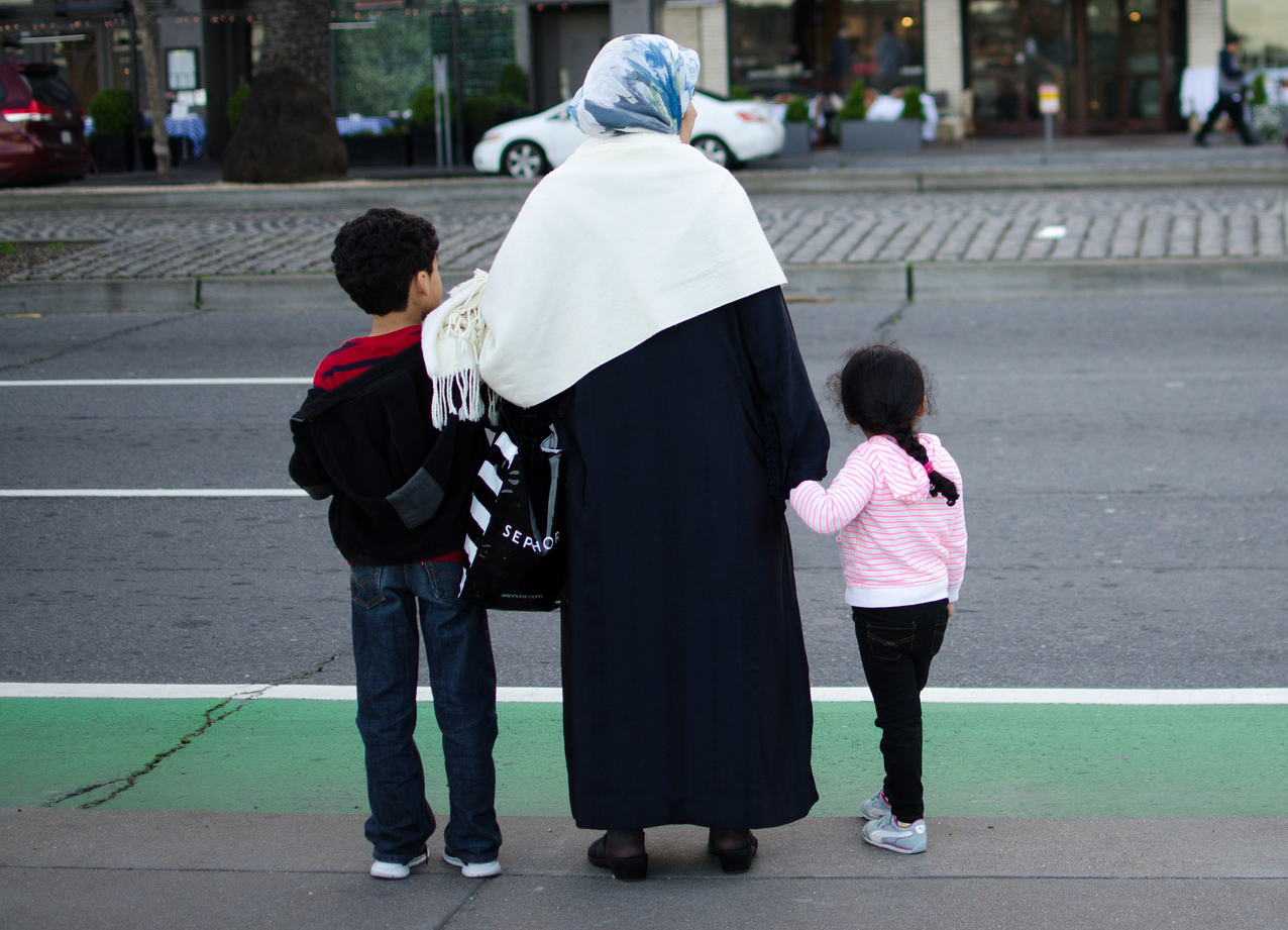 Refugee family crossing the street