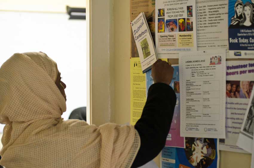 Muslim woman at noticeboard