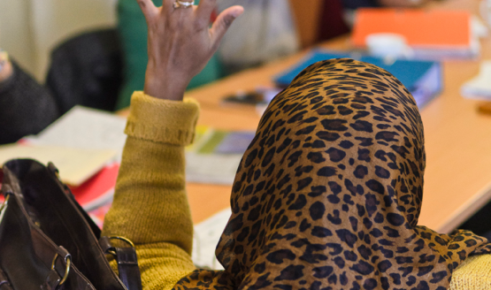 Muslim woman with hand raised